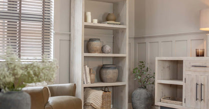 Wooden shelving unit in living room with ornaments on the shelves