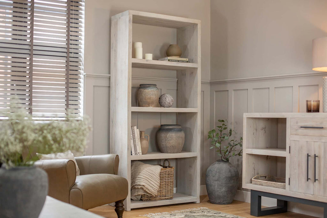 Wooden shelving unit in living room with ornaments on the shelves